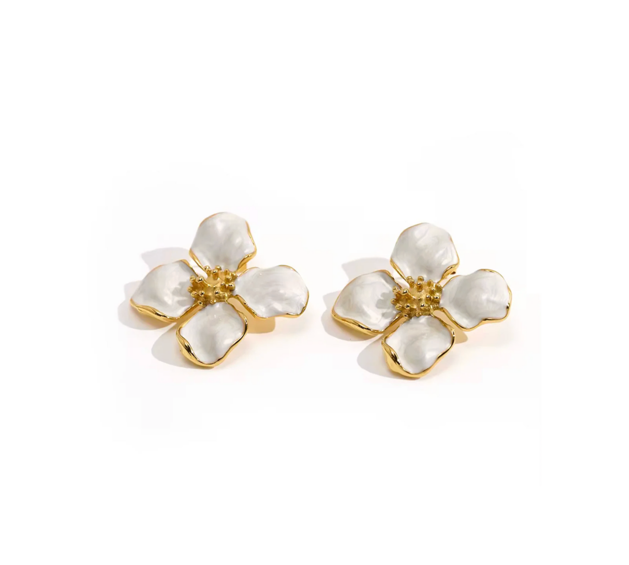 Pair of floral earrings with gold and white design on a white background