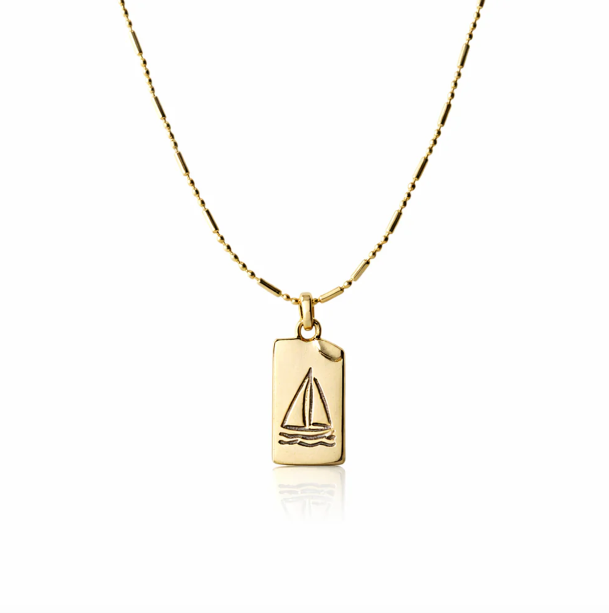 Gold necklace with a sailboat pendant on a white background