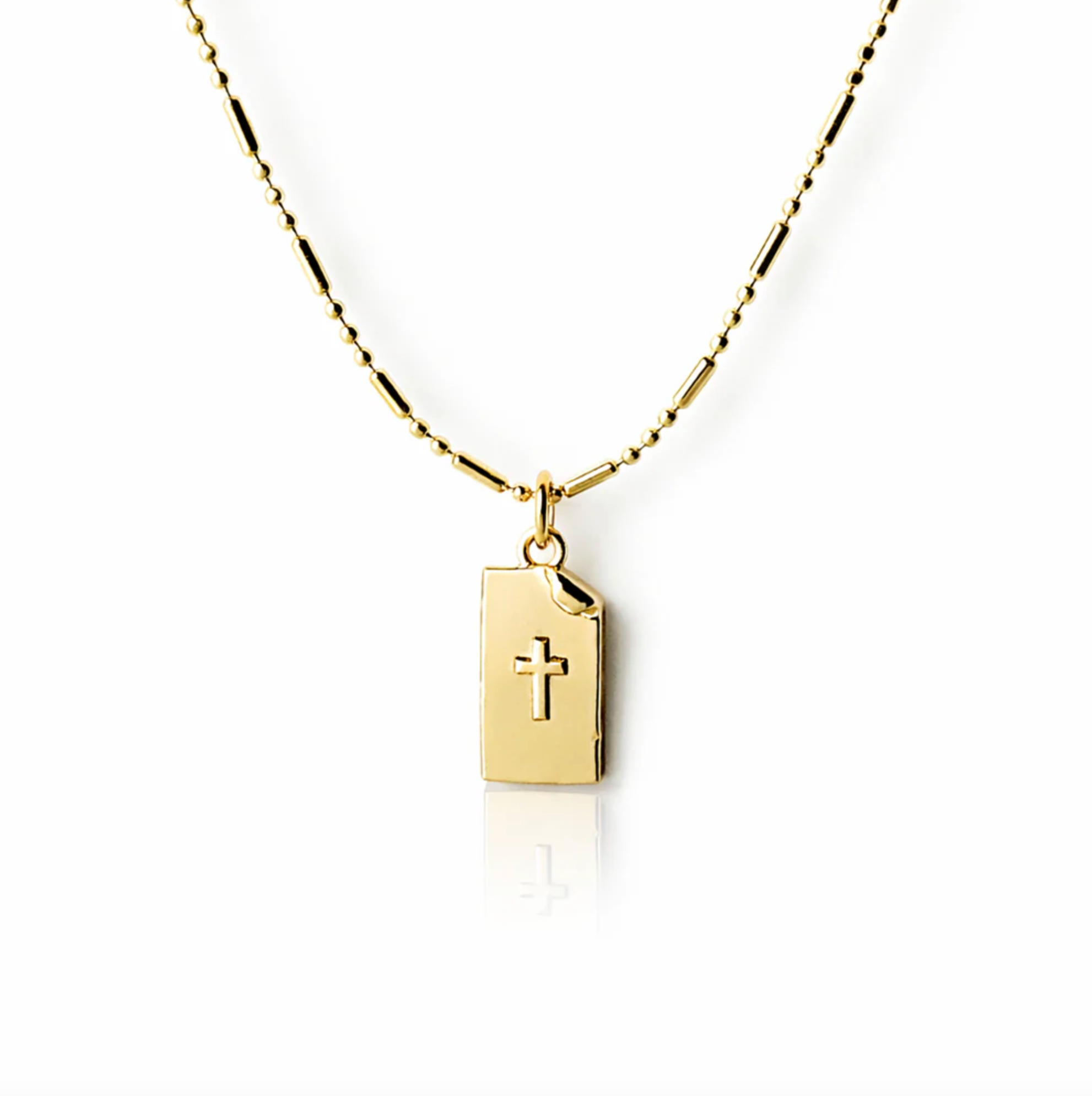 Gold necklace with a book-shaped pendant featuring a cross on a white background