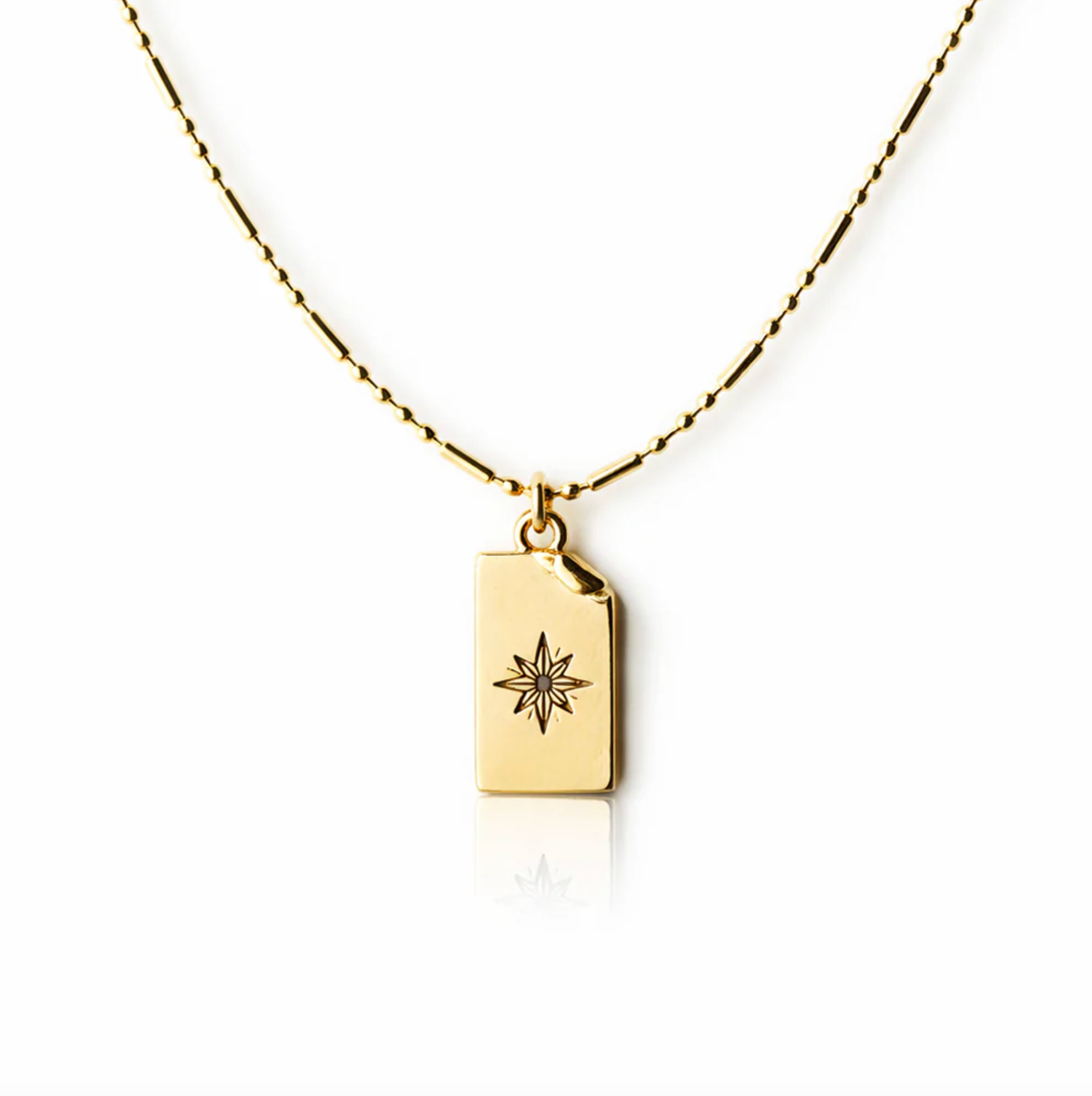Gold necklace with a rectangular pendant featuring a star design on a white background