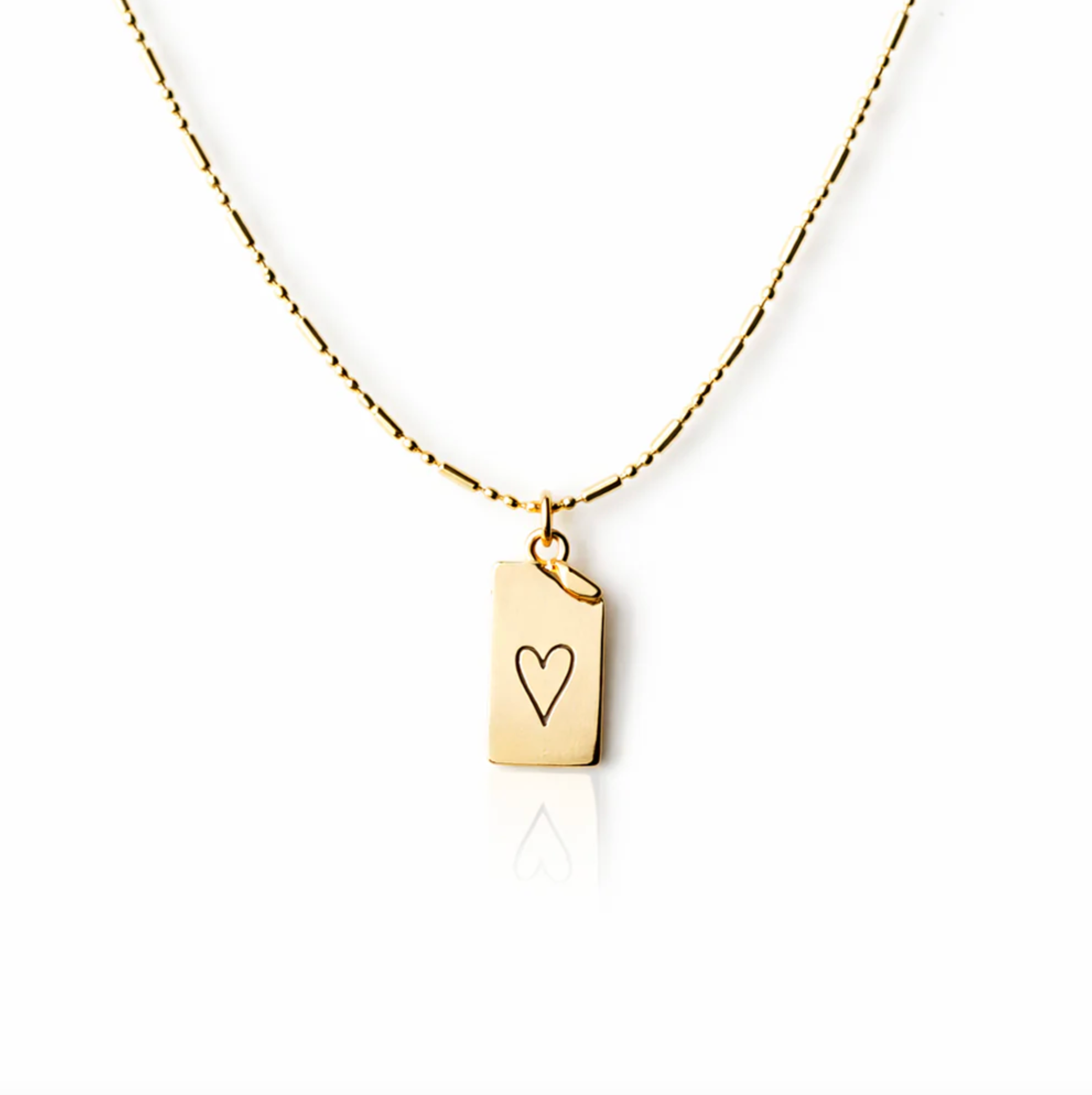 Gold necklace with a heart-shaped pendant on a white background