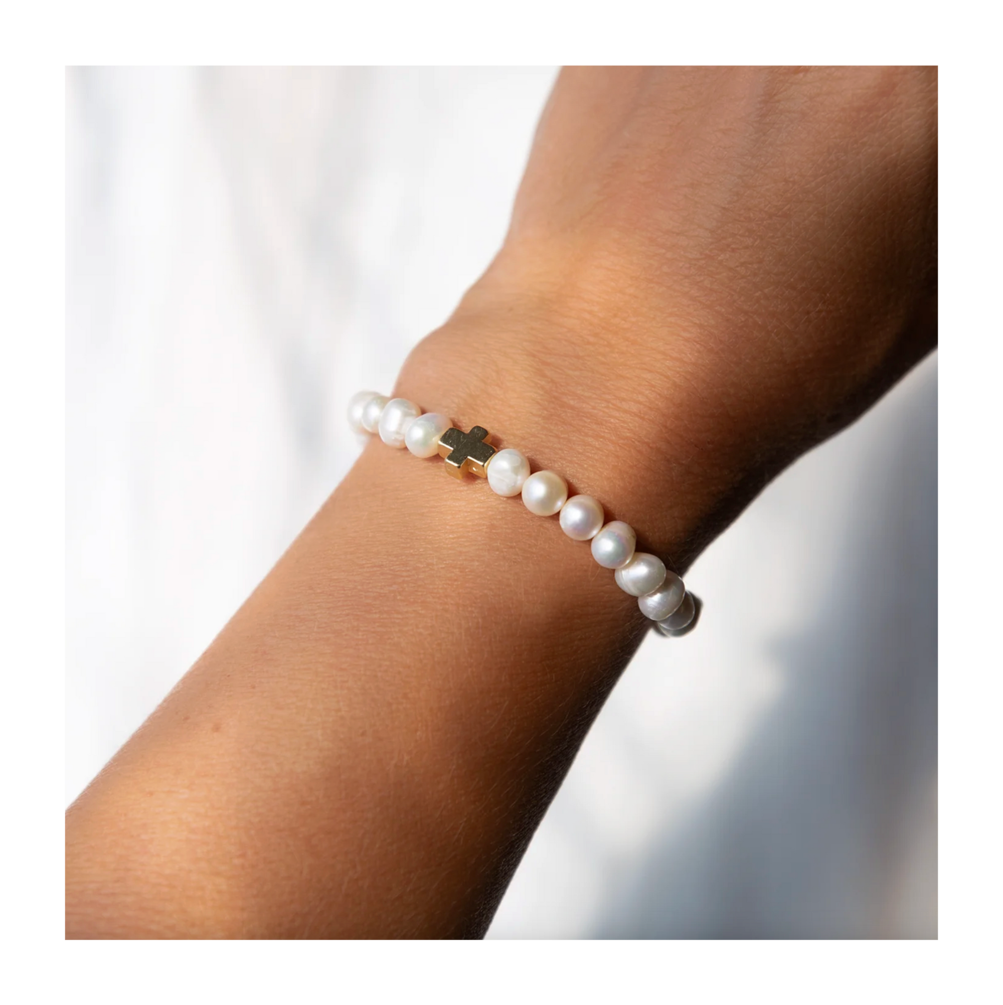 Pearl bracelet on a wrist with a blurred background