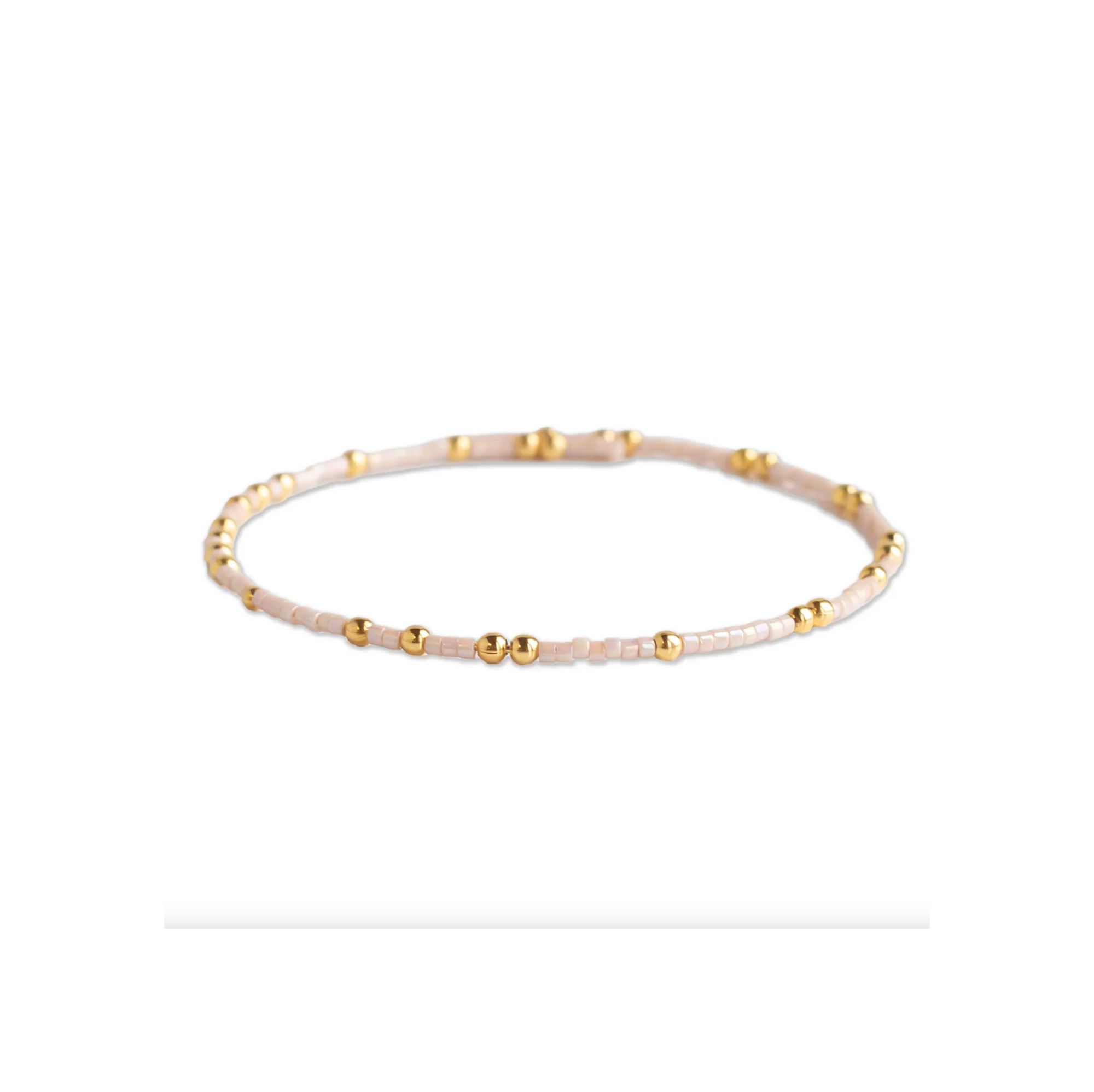 Bracelet with gold and beige beads on a white background