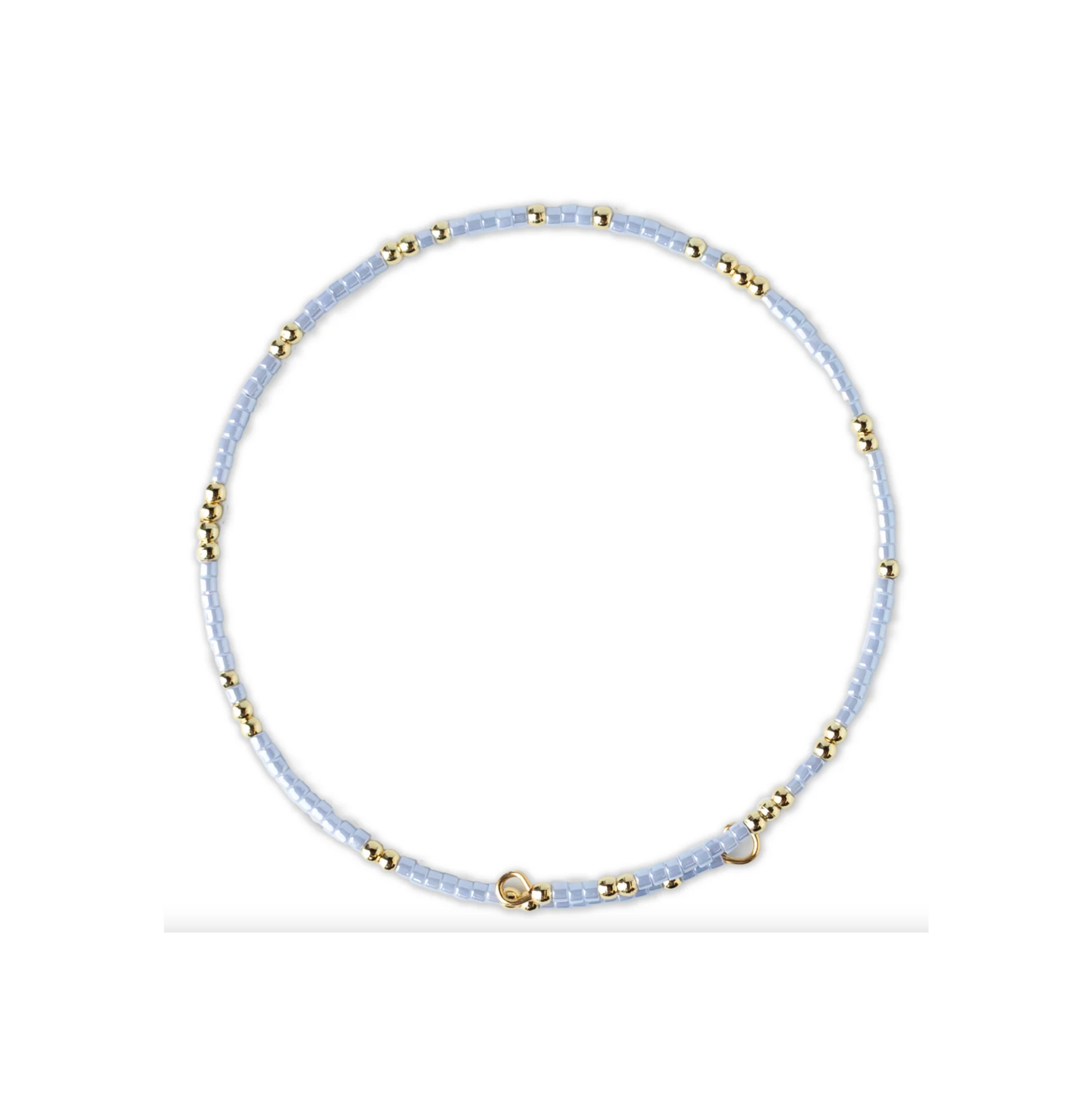 Necklace with light blue beads and gold accents on a white background