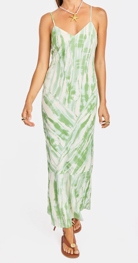Woman wearing a green tie-dye dress on a white background