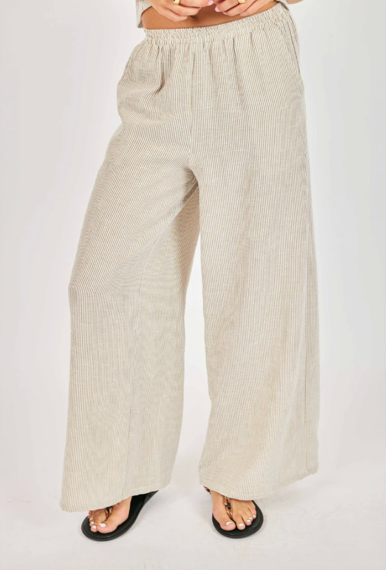 Beige wide-leg pants worn by a person on a white background