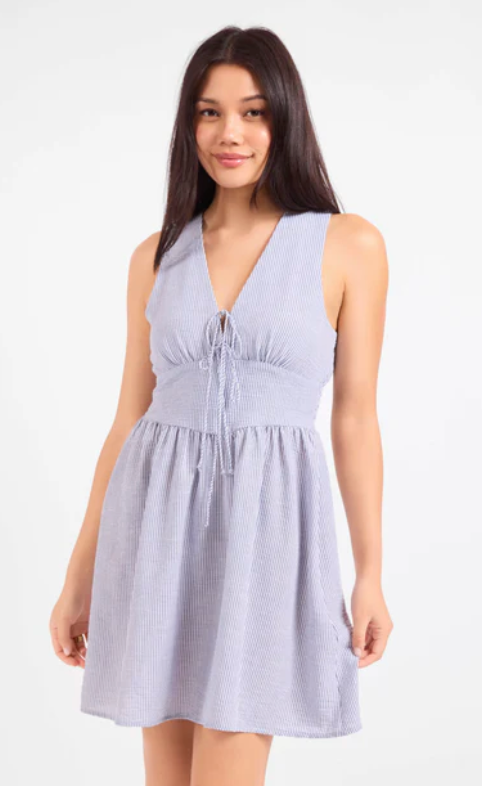 Woman wearing a light blue dress on a white background
