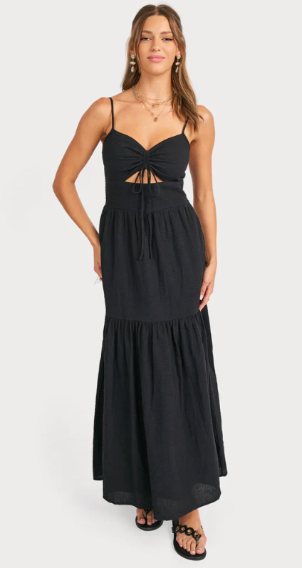 Woman wearing a black dress with cut-out details on a white background