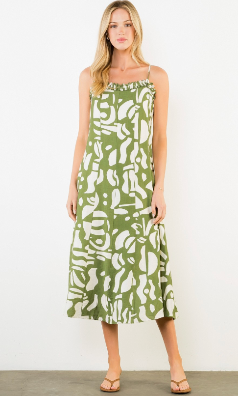 Woman wearing a green and white patterned dress against a white background