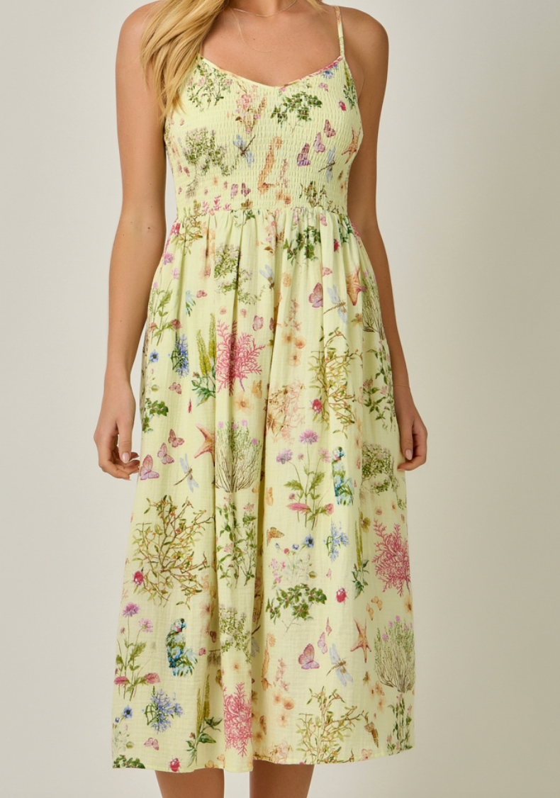Woman wearing a floral dress with a plain background