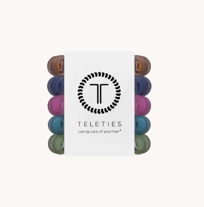 A pack of Teleties hair care caps shown in a vertical stack, partially obscured by a white paper sleeve featuring the black Teleties logo and brand name.