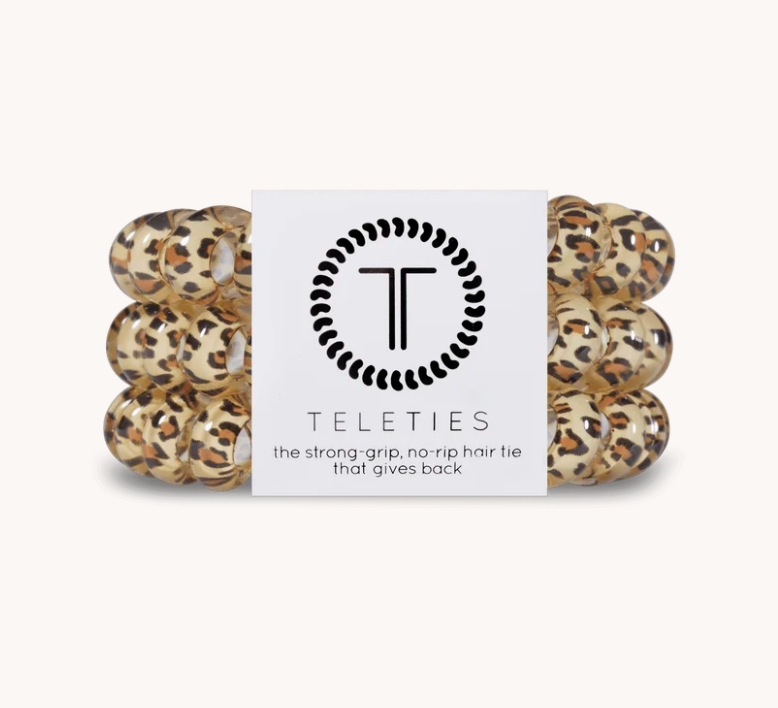 A pack of six Teleties hair ties in a leopard print pattern, wrapped together with a white paper band featuring the black Teleties logo and text.